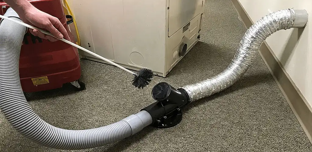 Dryer vent cleaning service removing lint from a dryer duct connection in Tucson, AZ