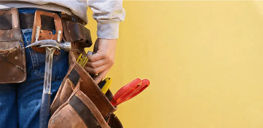 Handyman with tool belt ready for home repairs and maintenance in Tucson, AZ