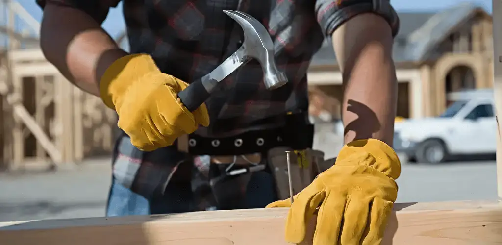 Handyman fixing wood trim with a hammer for home repairs in Tucson, AZ