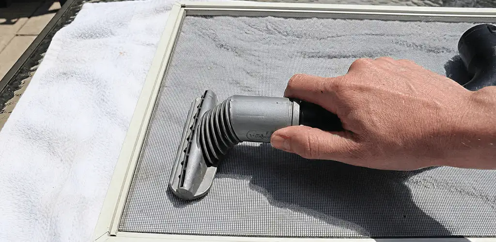 Window screen repair cleaning and fixing a damaged screen mesh in Tucson, AZ